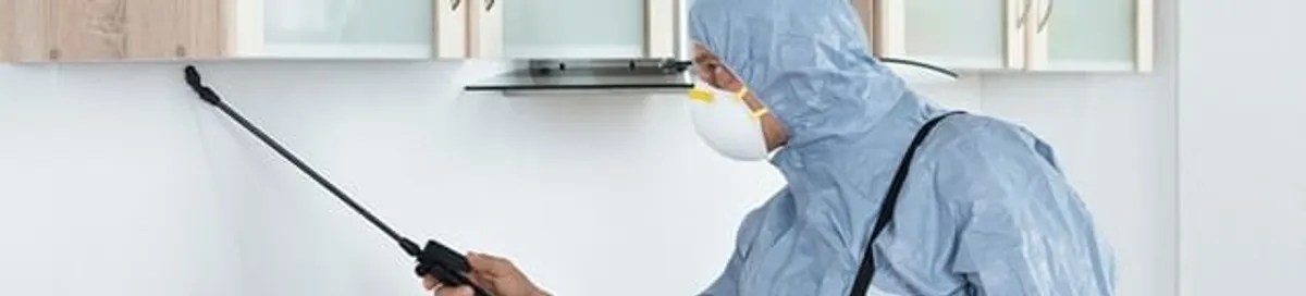 Termite treatment technician applying indoor pest control spray in San Jose, CA