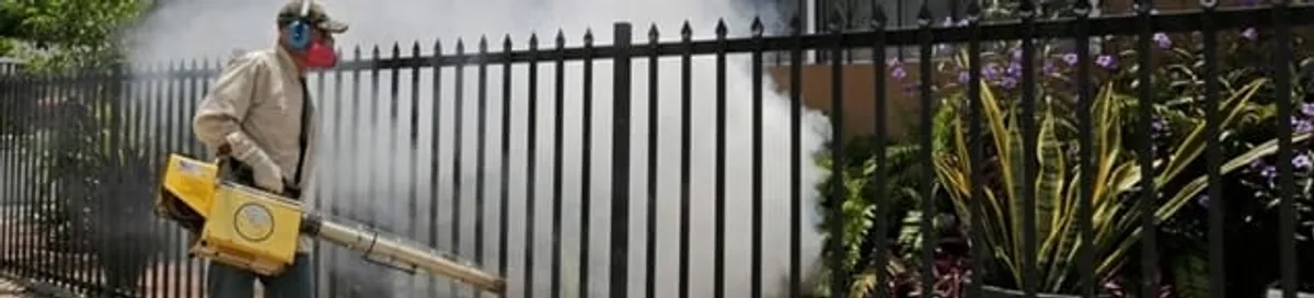Mosquito control technician fogging a yard perimeter for mosquito reduction in San Jose, CA